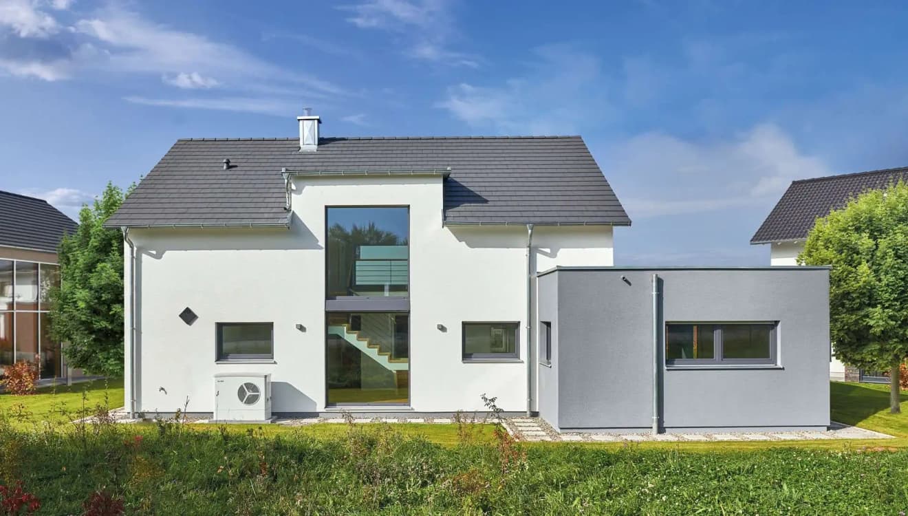 Modernes Fertighaus mit kubischem Anbau und Wärmepumpe